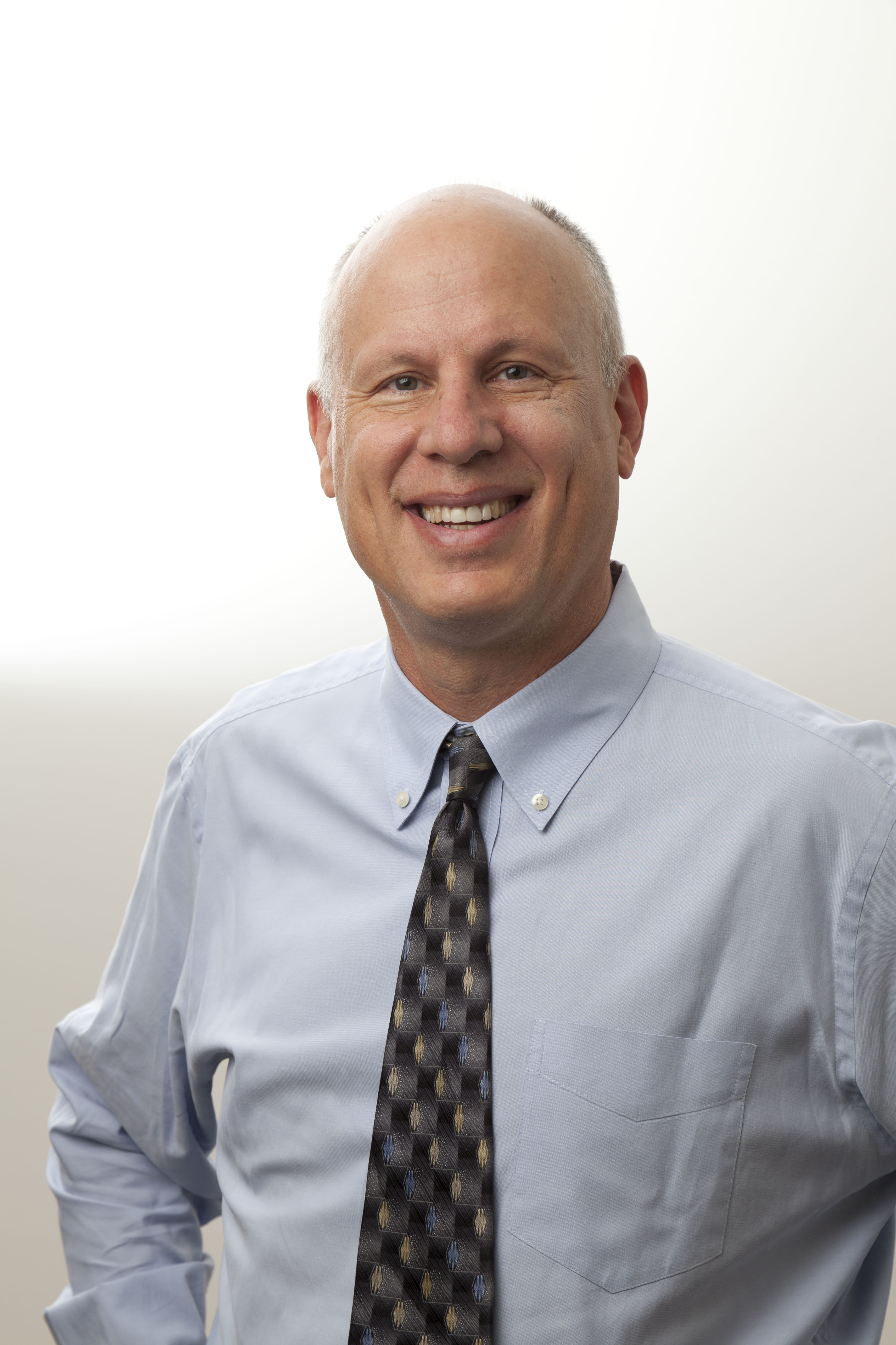 Smiling man standing and looking at camera